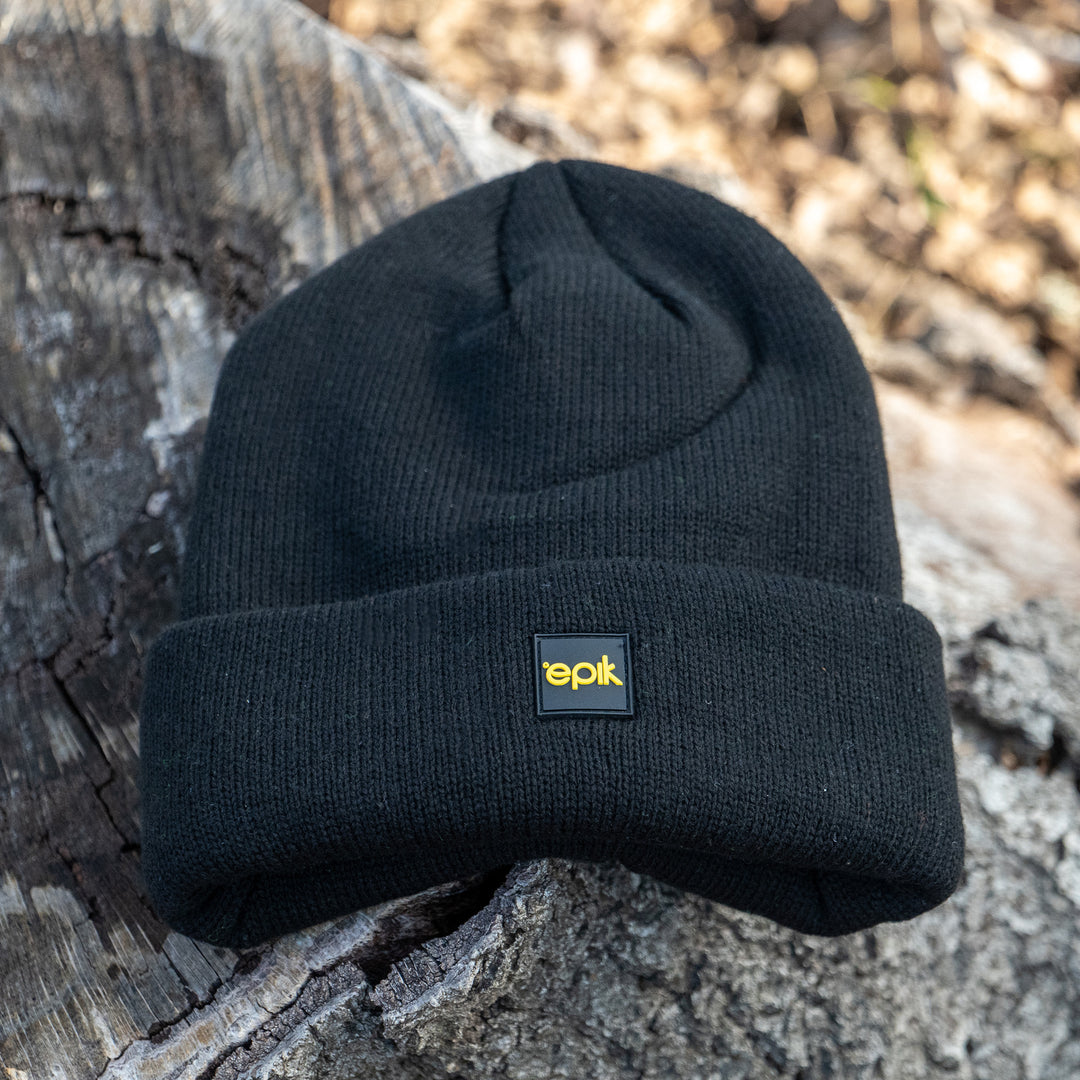 Epik Charcoal Black Thermal Beanie on outerwear log tree