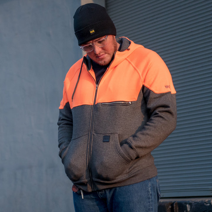 Peak Hoodie in Hi Vis orange Sunset outside warehouse